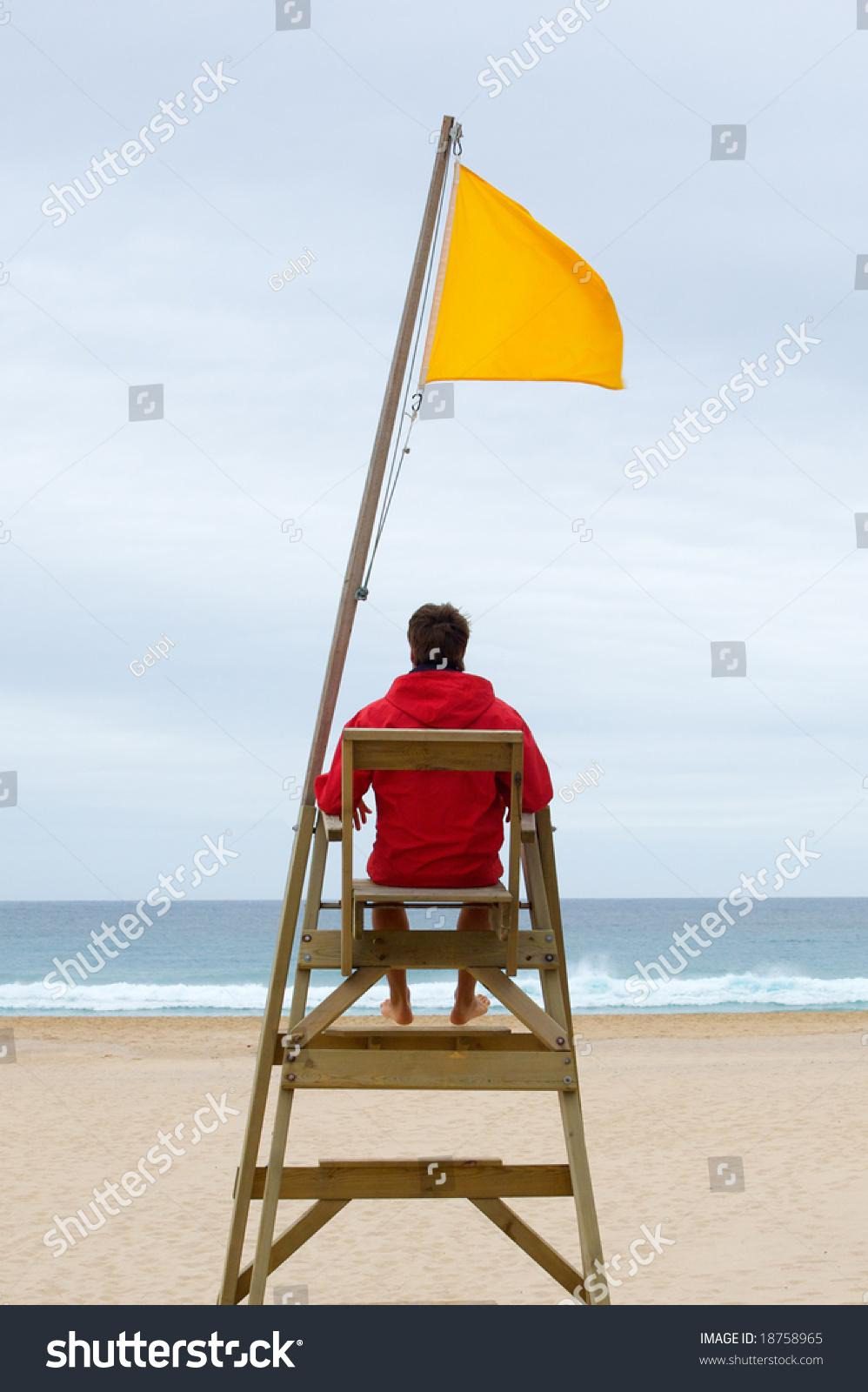 Lifeguard Sitting His Chair Watching Sea Stock